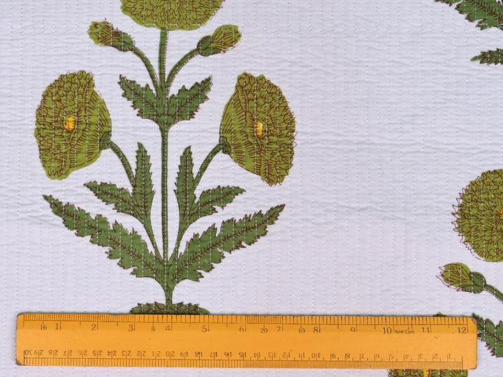 Pre-cut quilted fat quarter bundle with ruler and scissors for scale