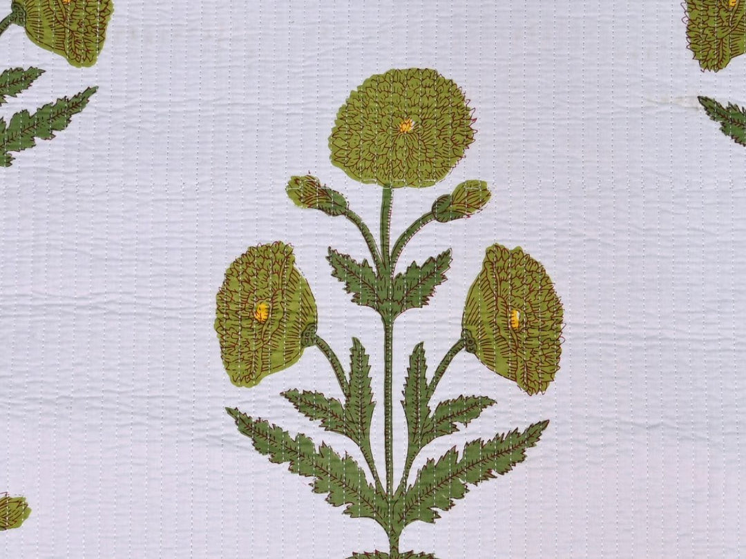Close-up of green marigold floral quilted fabric with serrated leaves