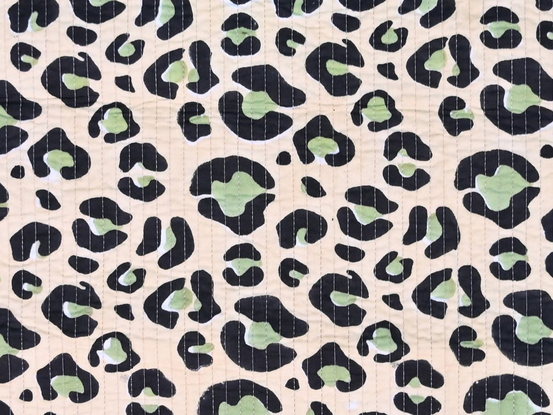 Reversible quilted fabric with green and white striped reverse side