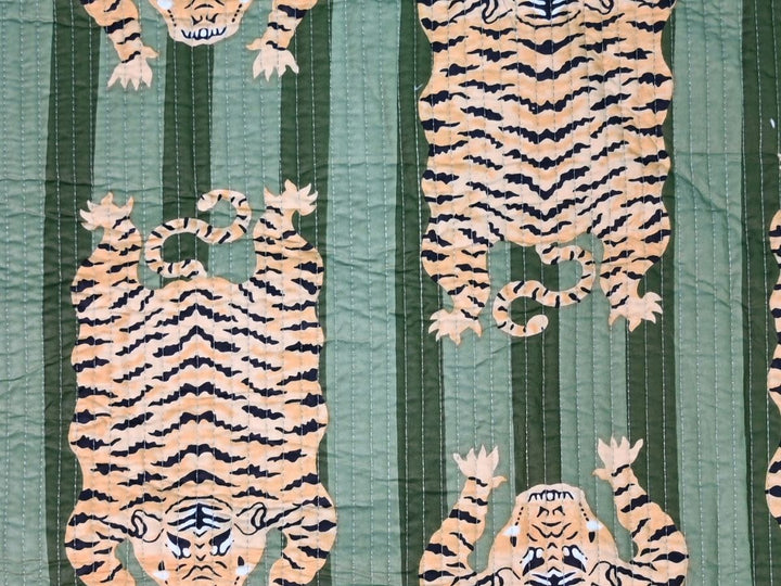 Green tiger quilted fabric showing quilted stitching and orange-tan tigers
