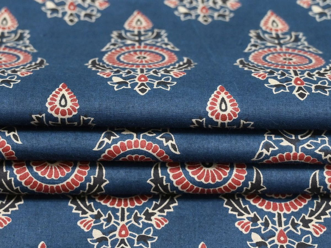 Close-up of indigo block print fabric showing rose and white floral motifs