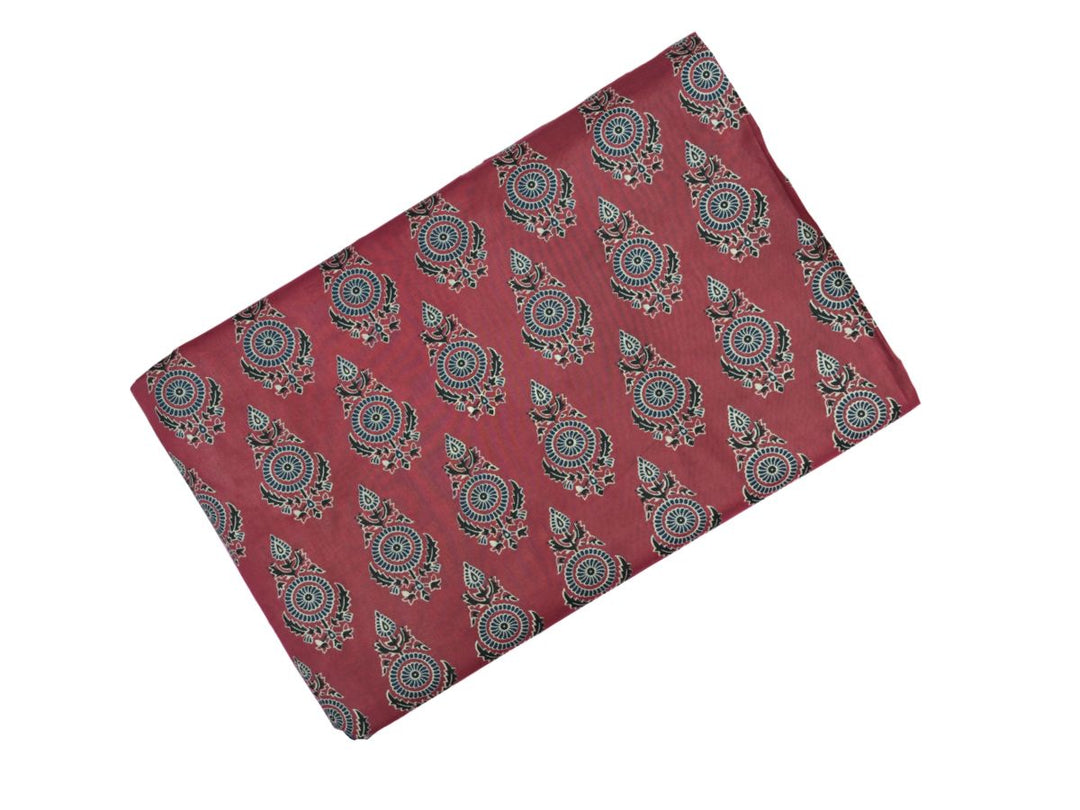 Close-up of Bagru print fabric showing blue and white floral motifs on maroon