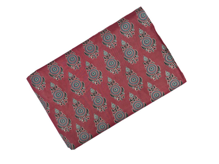 Close-up of Bagru print fabric showing blue and white floral motifs on maroon