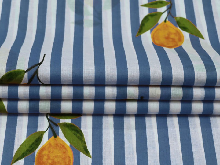 Close-up of blue lemon stripe cotton fabric with yellow lemon motifs