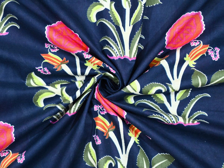 Traditional Indian block printed fabric showing orange buds and green leaves