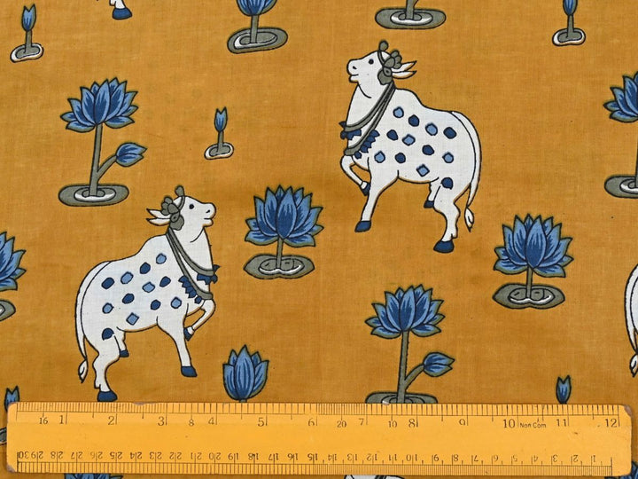 Close-up of Pichwai-style cotton fabric with cow and lotus details