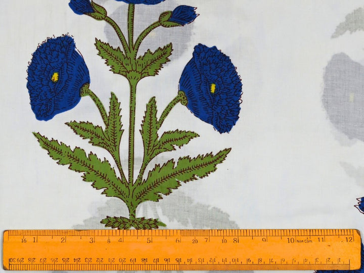 White floral print fabric showing blue flowers and yellow centers