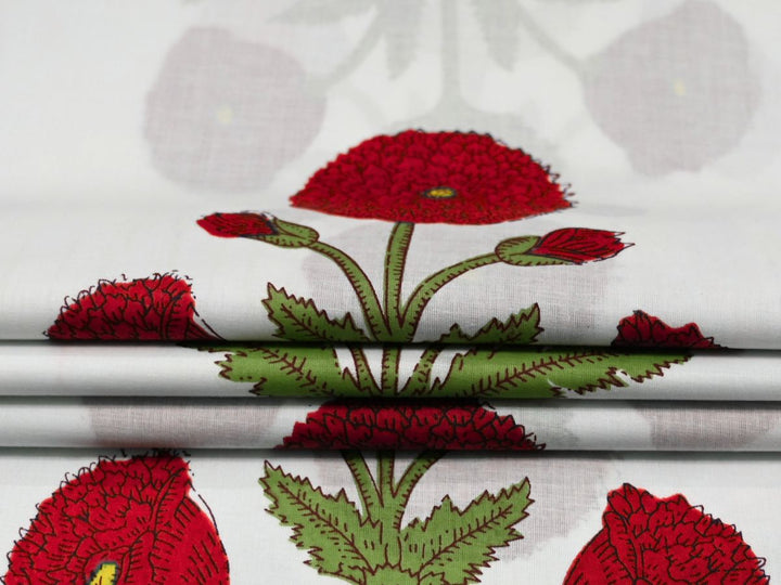 Close-up of red poppy block print fabric showing yellow flower centers