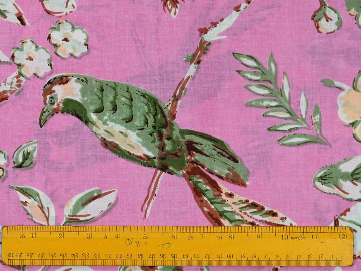 Close-up of pink chinoiserie cotton fabric with bird and floral details