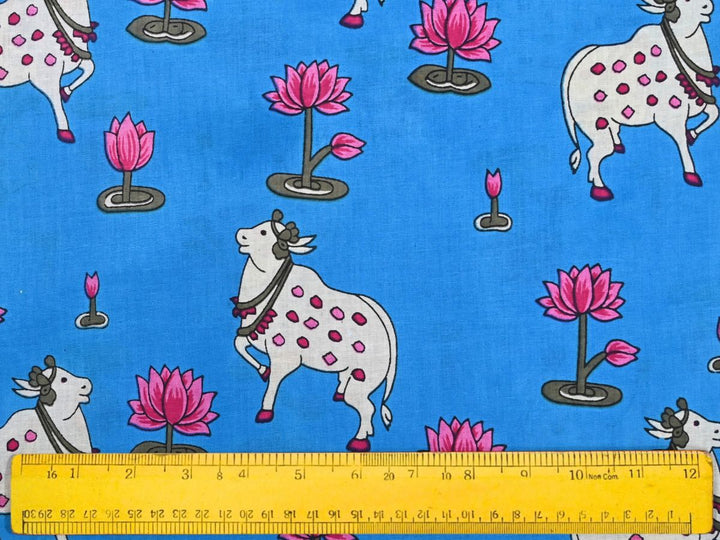 Close-up of Pichwai-style animal print cotton fabric with cow and lotus details