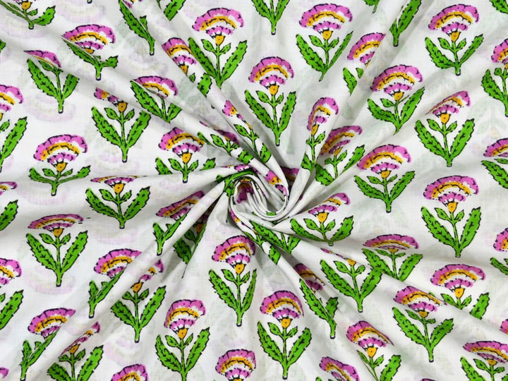 White cotton fabric showing pink and yellow fan-shaped flowers
