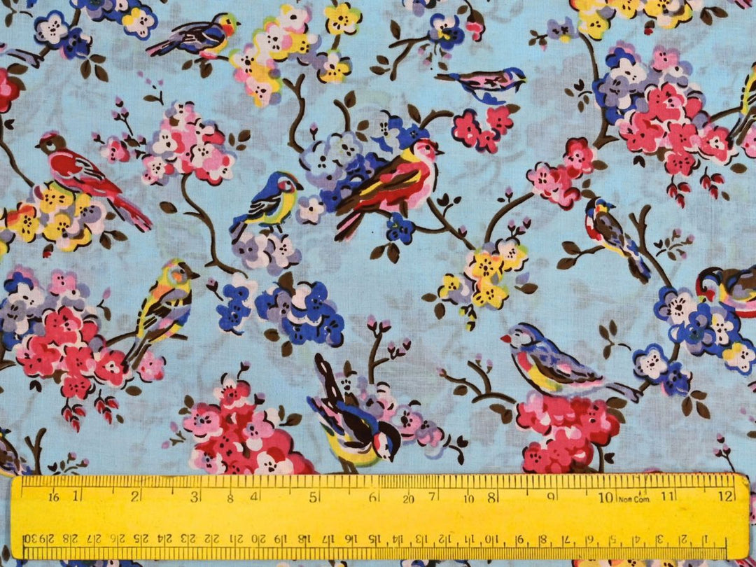 Printed cotton fabric with folk-art bird and blossom pattern on grey