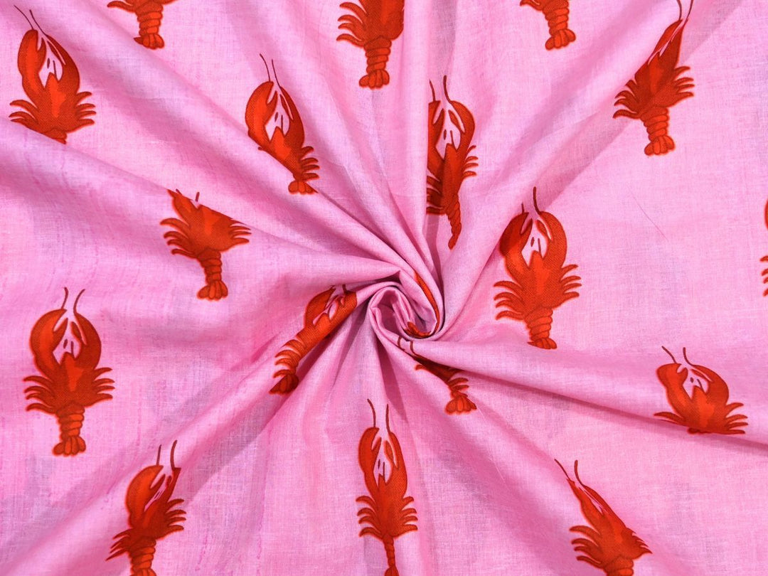 Pink cotton fabric showing red-orange lobster novelty motif