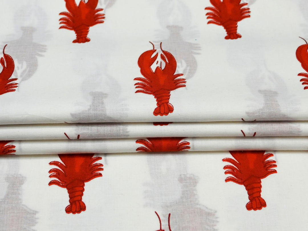 Close-up of red lobster print cotton fabric with white lobster details
