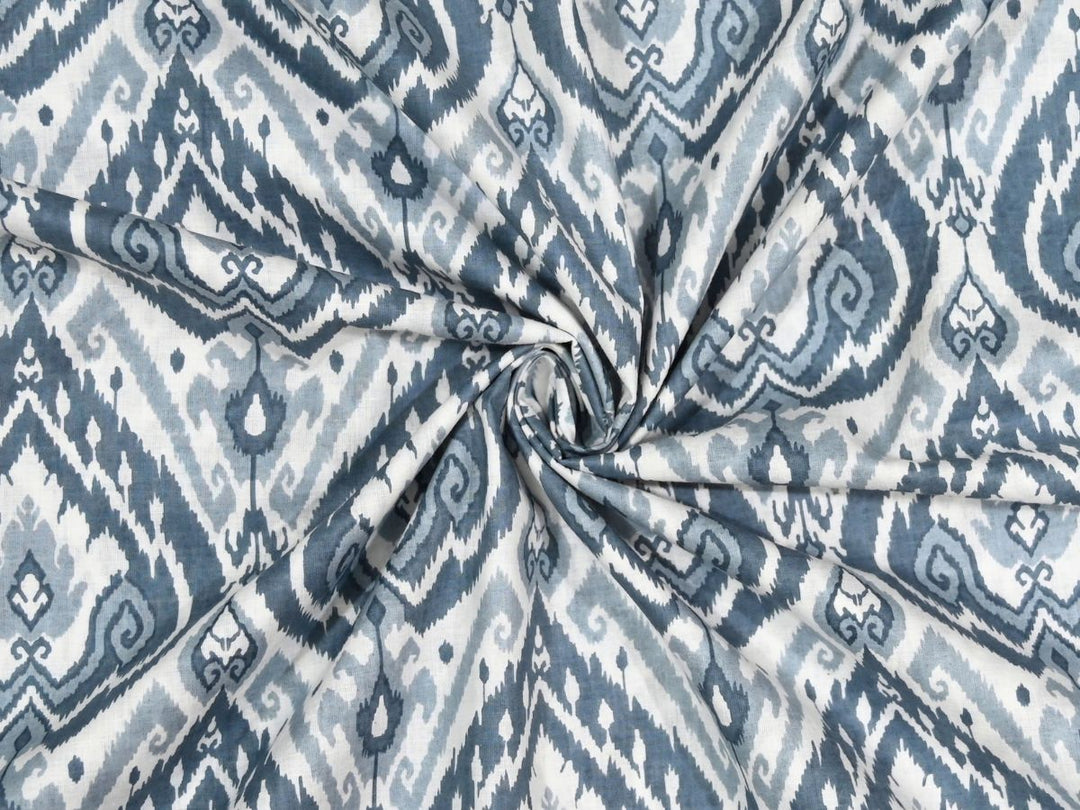 Close-up of blue ikat print cotton fabric with slate blue and grey details