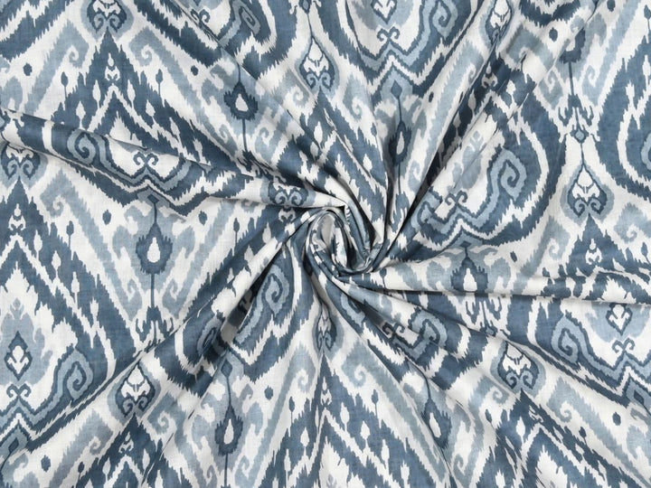 Close-up of blue ikat print cotton fabric with slate blue and grey details