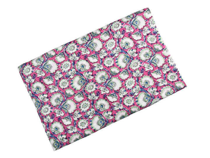 Dense floral block print fabric showing Indian folk-art pattern on pink
