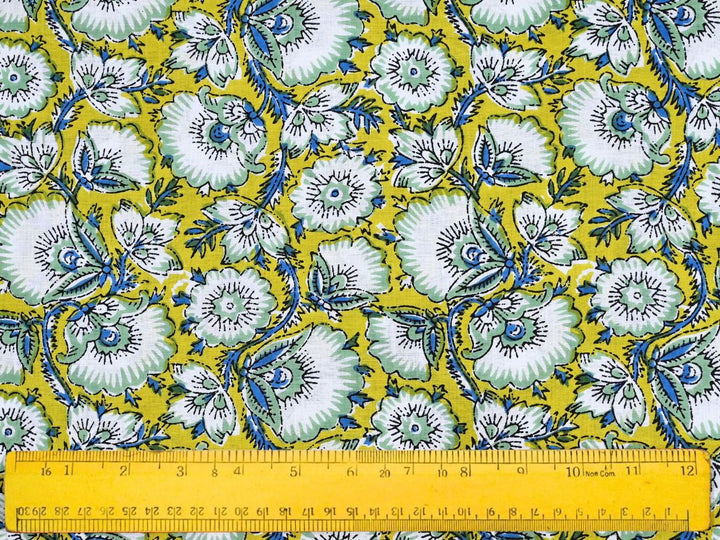 Yellow floral block print cotton fabric with white and mint green flowers