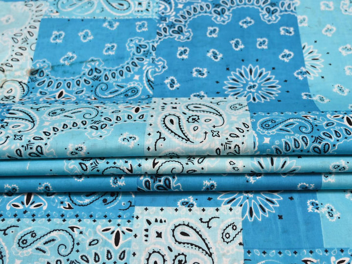 Blue bandana patchwork fabric showing paisley, floral, and star motifs