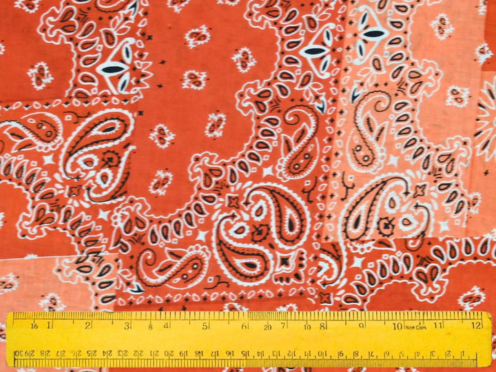 Close-up of orange bandana patchwork fabric with dotted border details
