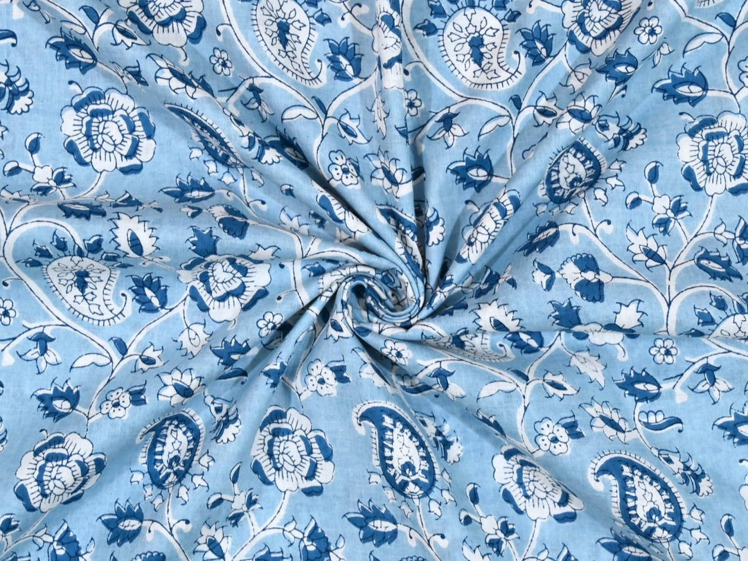 Light blue paisley block print cotton fabric with navy and white motifs