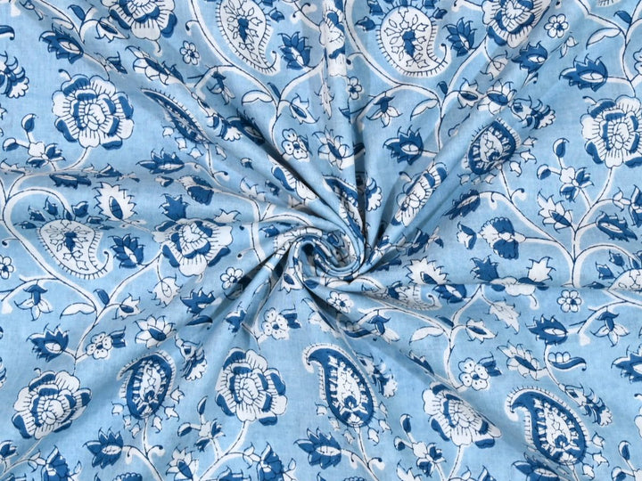 Light blue paisley block print cotton fabric with navy and white motifs