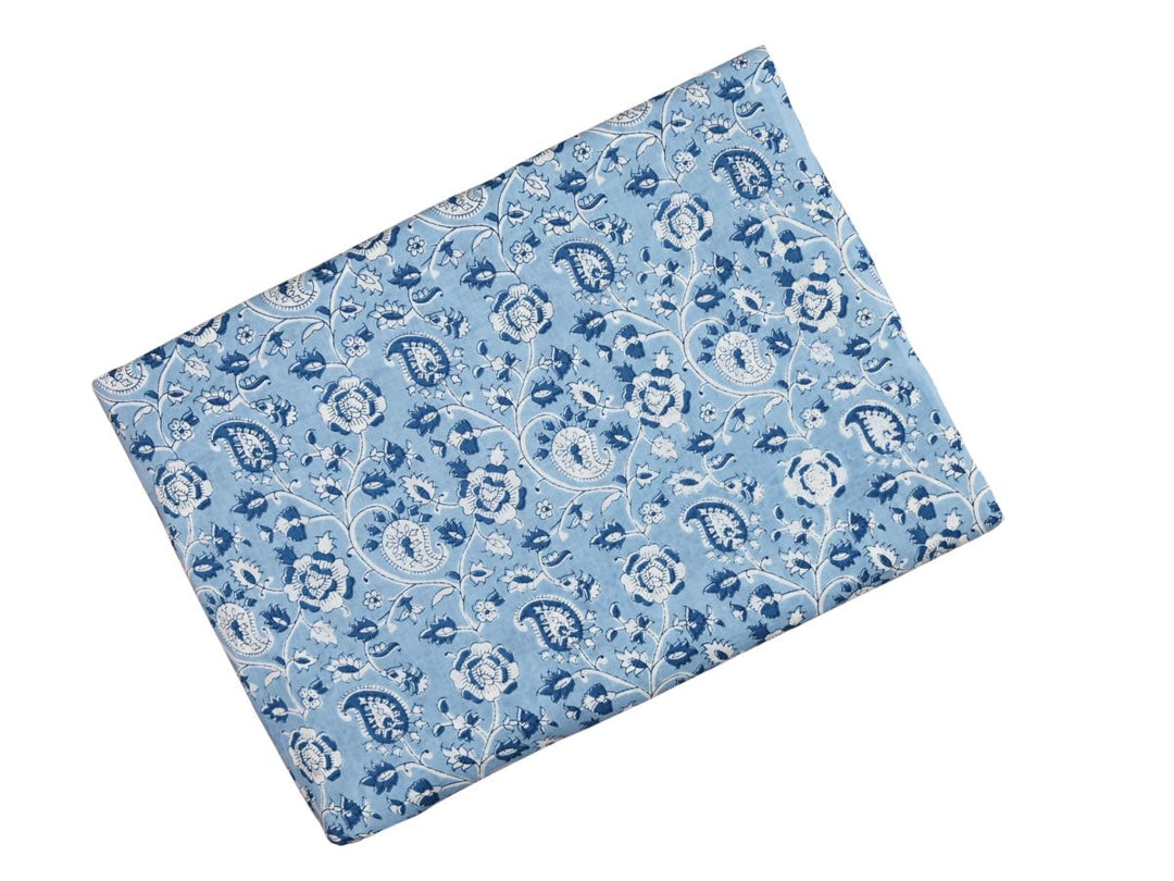 Traditional paisley and floral block print fabric on light blue ground