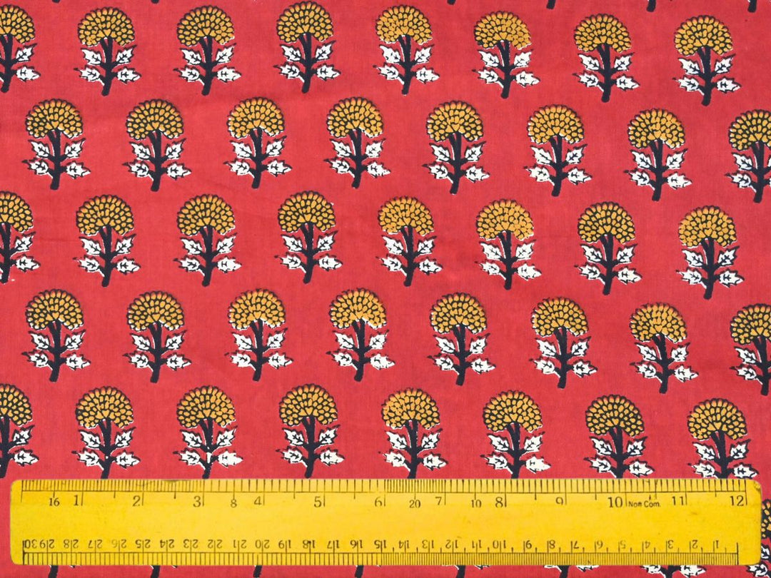 Traditional Indian block print fabric with floral sprig repeat on red