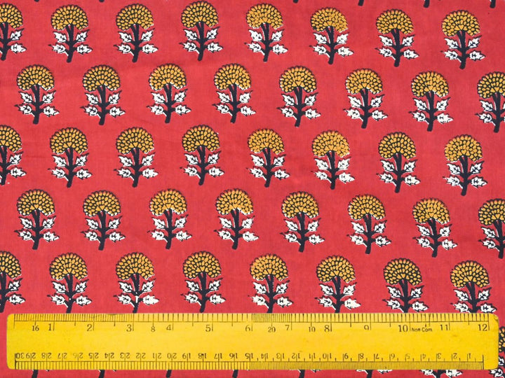 Traditional Indian block print fabric with floral sprig repeat on red