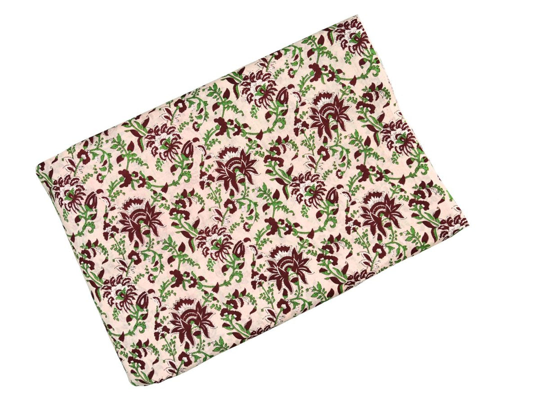 Indian block print fabric with dense botanical pattern on cream ground