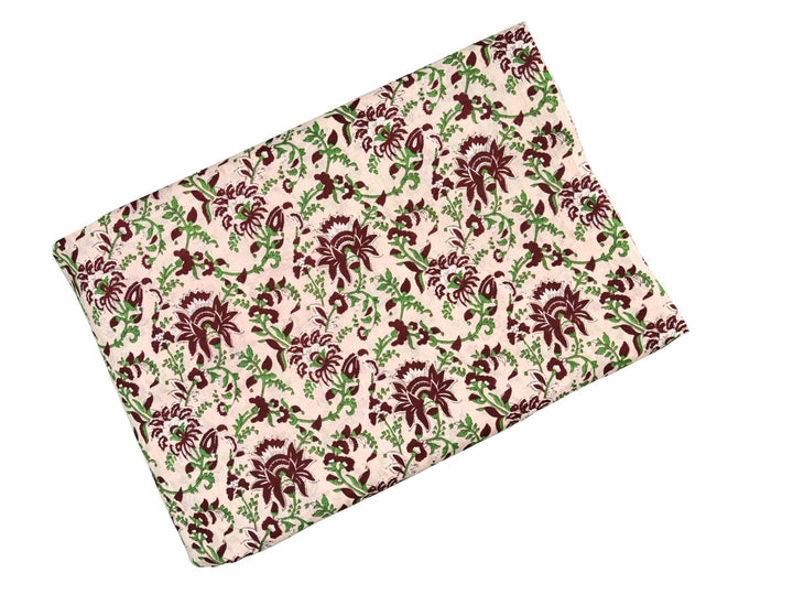 Indian block print fabric with dense botanical pattern on cream ground