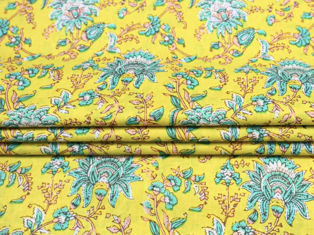 Close-up of chartreuse woodblock floral fabric with teal scalloped petals