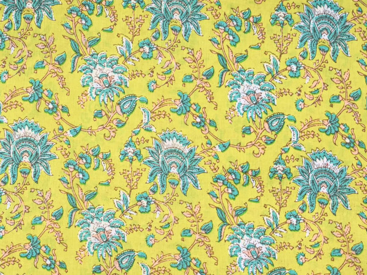 Chartreuse quilting cotton fabric with teal and white stylized flowers