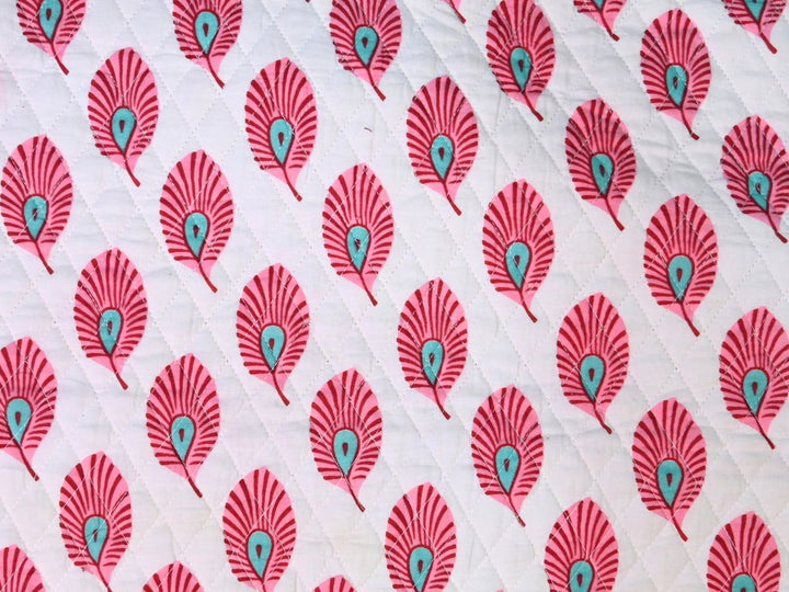 Reversible quilted fabric with pink and white striped reverse
