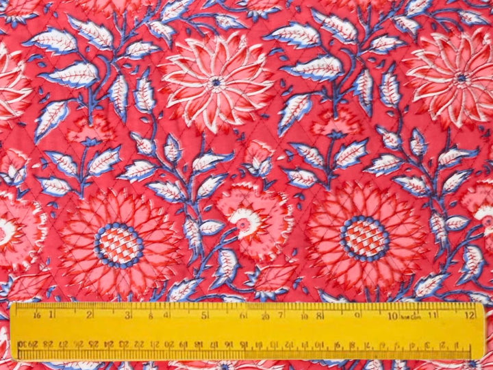 Reversible quilted fabric with red and white striped reverse
