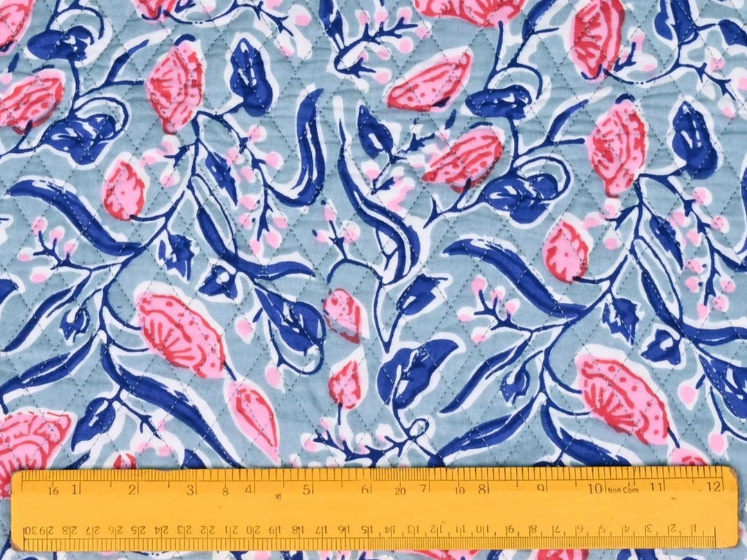 Quilted floral block print fabric with diamond stitch lines