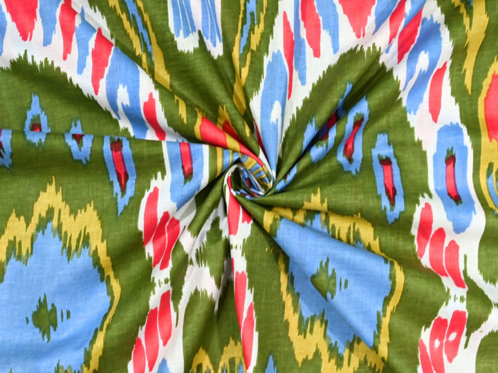 Olive green ikat cotton fabric showing feathered-edge geometric pattern