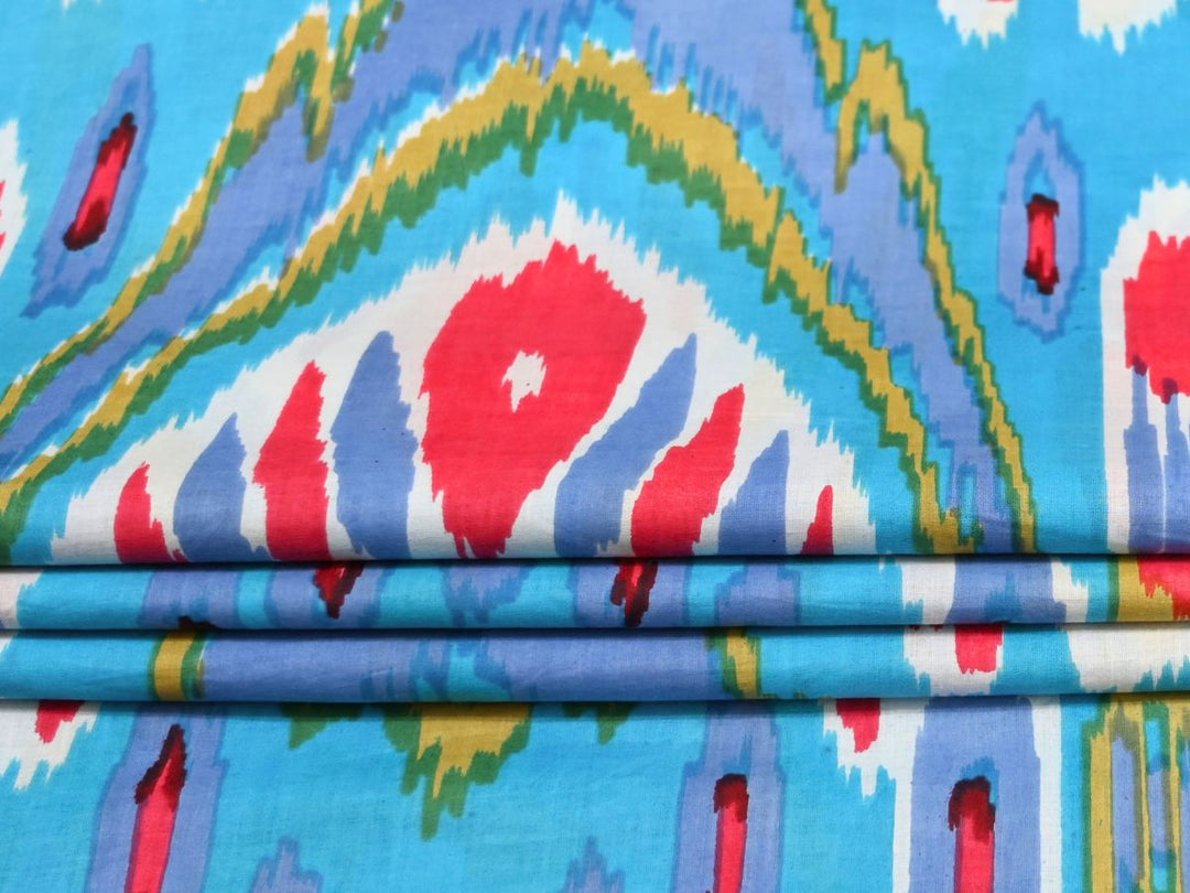 Sky blue ikat cotton fabric showing feathered-edge geometric pattern