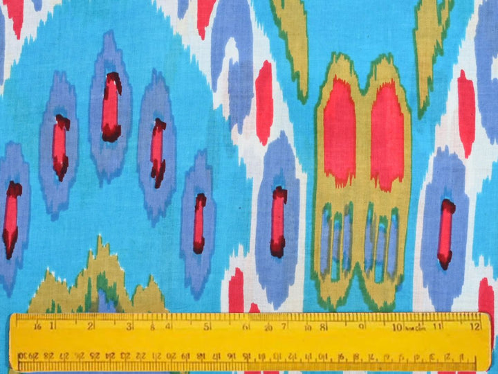 Close-up of sky blue ikat fabric with bold patterned motifs