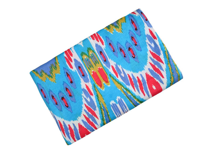 Traditional Indian ikat print fabric with red, white, and mustard yellow accents