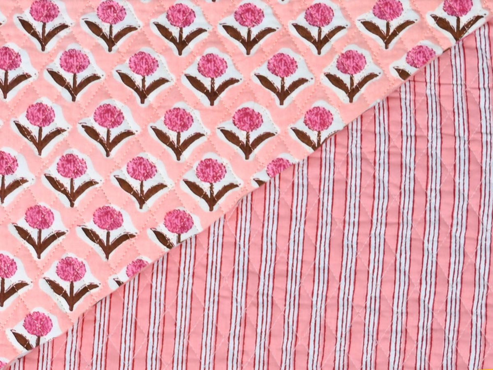 Peach floral quilted fabric by the yard with pink carnation-style blooms