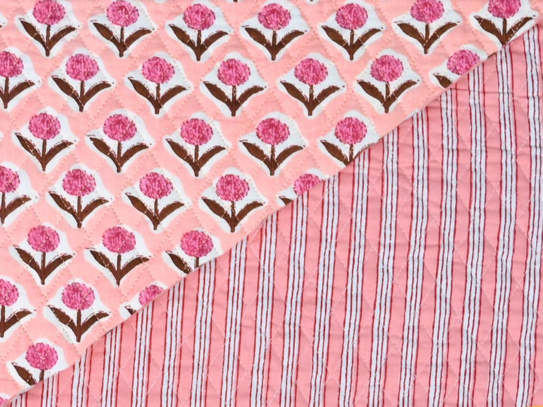 Peach floral quilted fabric by the yard with pink carnation-style blooms