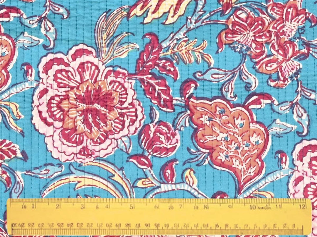 Quilted floral fabric with maroon foliage and yellow accents