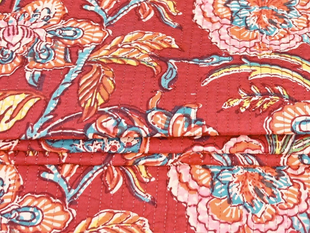 Reversible quilted fabric with red and white striped reverse
