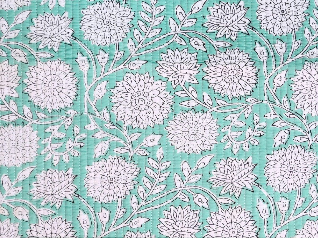 Reversible quilted fabric with green white and red striped reverse