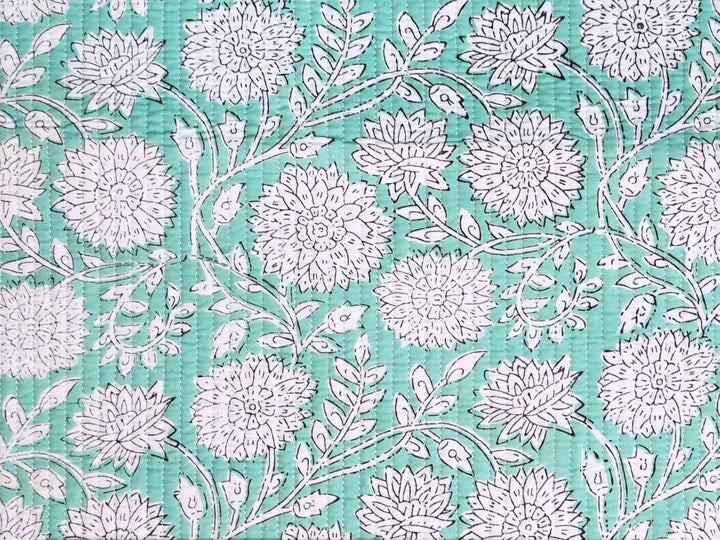 Reversible quilted fabric with green white and red striped reverse