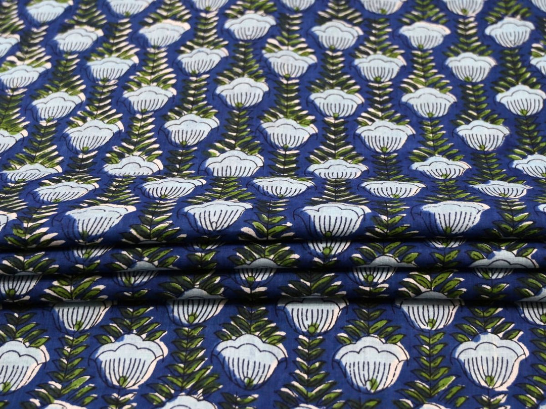 Cobalt blue cotton fabric by the yard with white shell-shaped flower repeat