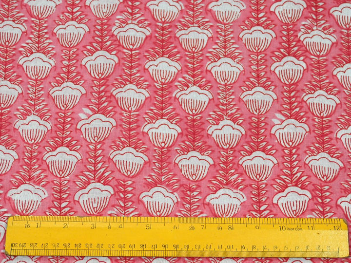 Close-up of peach floral cotton fabric with detailed white linework and leaf details