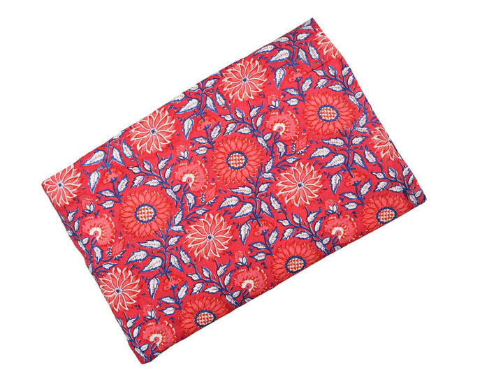 Dense floral block print fabric on red ground with checkered flower centers