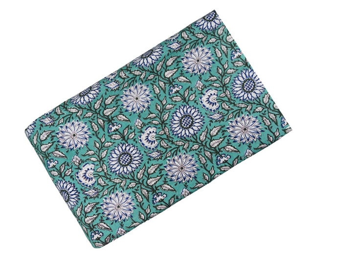 Close-up of mint green floral cotton fabric with detailed floral linework